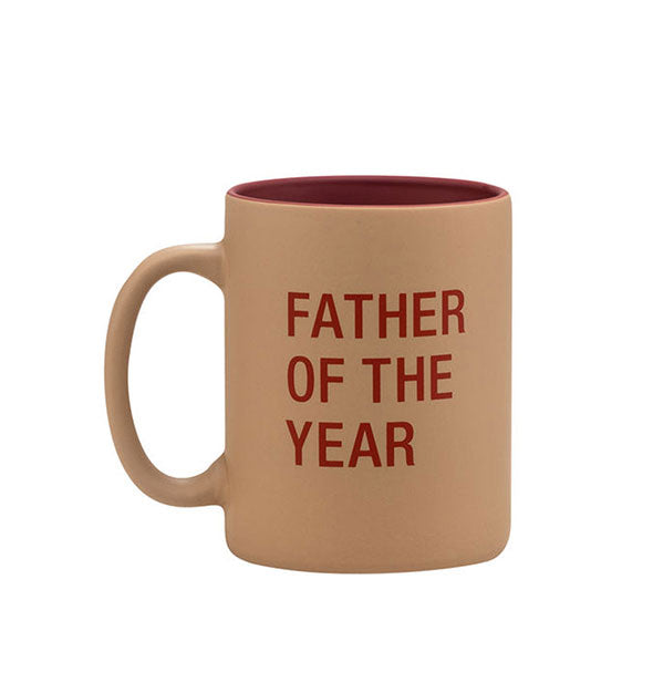 Brown coffee mug with dark red interior and lettering says, "Father of the year"