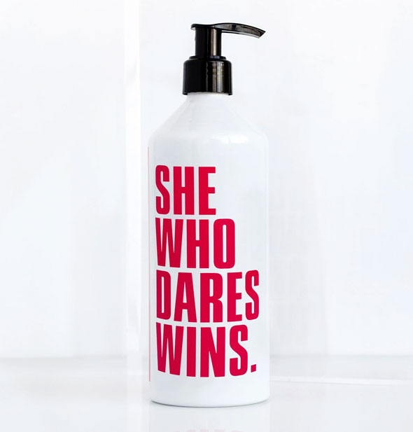 14 ounce pump bottle says, "She Who Dares Wins."