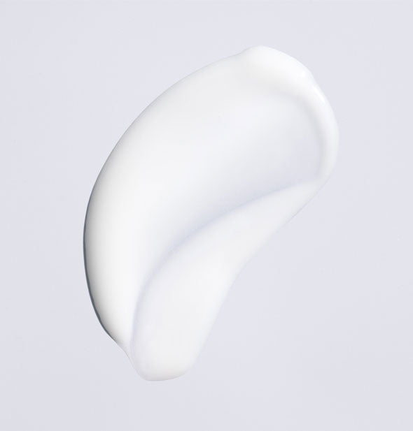 Sample of Oribe Featherbalm Weightless Styler shows product color and consistency