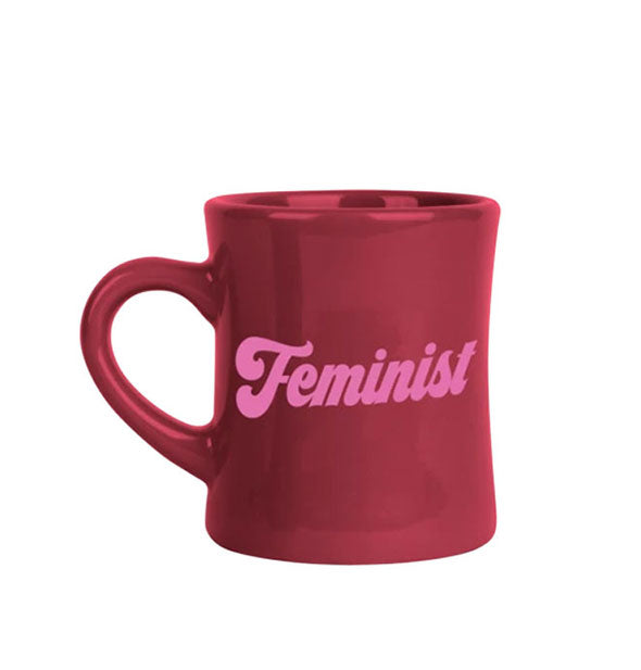 Burgundy diner coffee mug says, "Feminist" in pink lettering