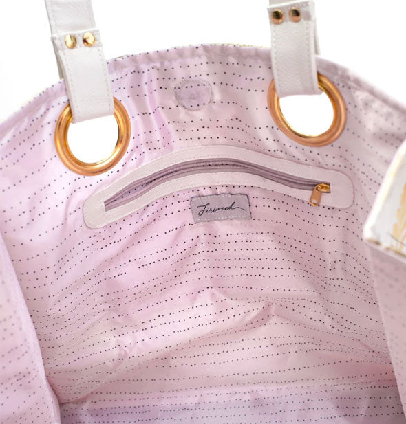 Tote bag interior with purple patterned lining, zipper pocket, and gold handle hardware