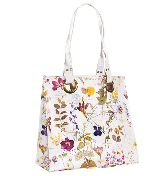 White tote bag with all-over pressed flower design, geometric accents, and gold hardware