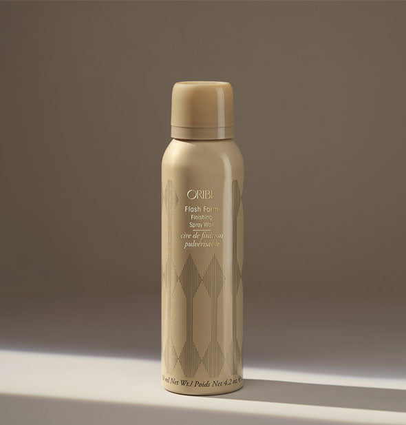 Gold can of Oribe Flash Form Finishing Spray Wax on neutral background
