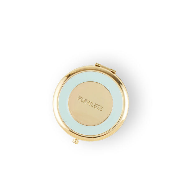Round blue and gold compact mirror says, "Flawless" engraved in the center