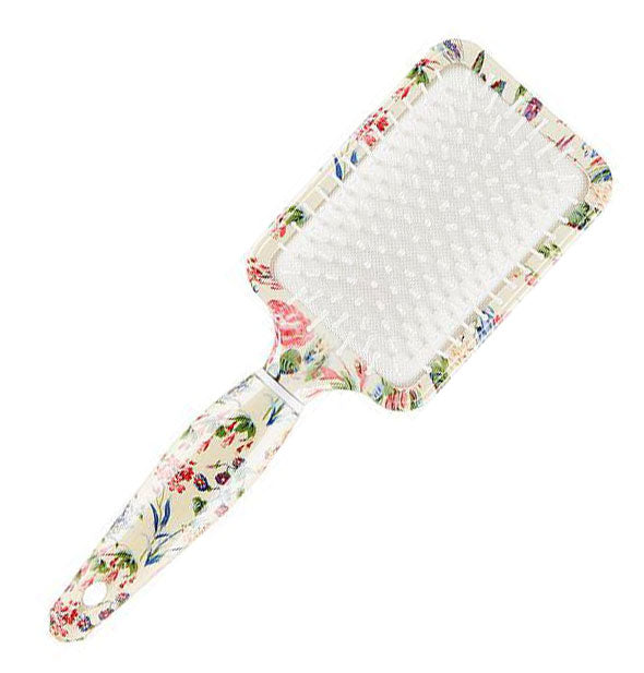 Floral print rectangular paddle brush with white bristles and bristle bed