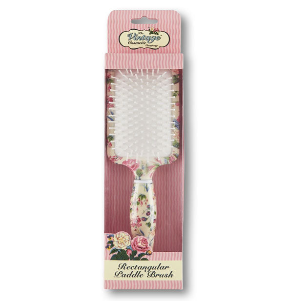Floral rectangular hairbrush by The Vintage Cosmetic Company in pink striped packaging