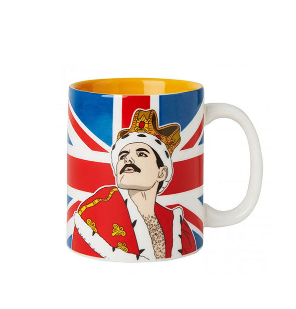 Coffee mug with yellow interior features illustration of Freddie Mercury in the king costume he wore at Wembley Stadium in 1986 in front of an all-over Union Jack design
