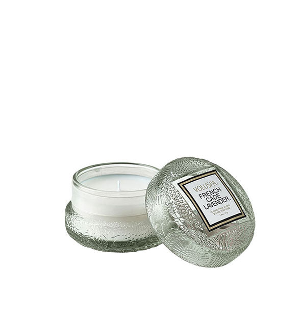 Small embossed gray-green glass jar French Cade Lavender Voluspa candle with lid removed