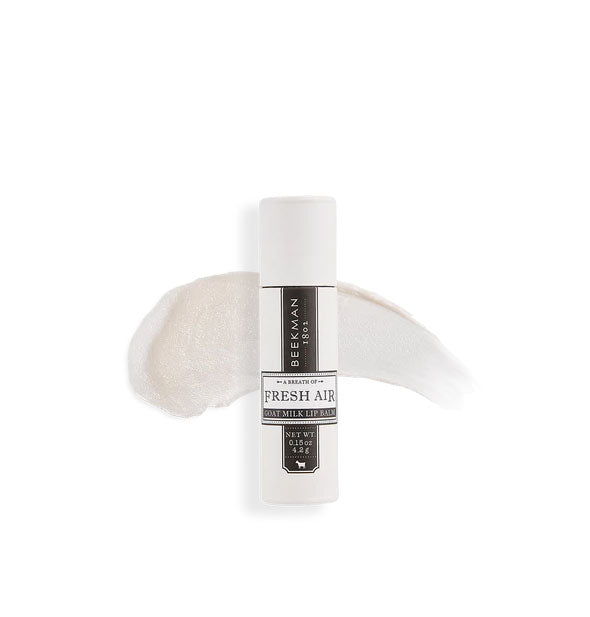 White and black tube of Beekman 1802 Fresh Air lip balm with sample product application behind