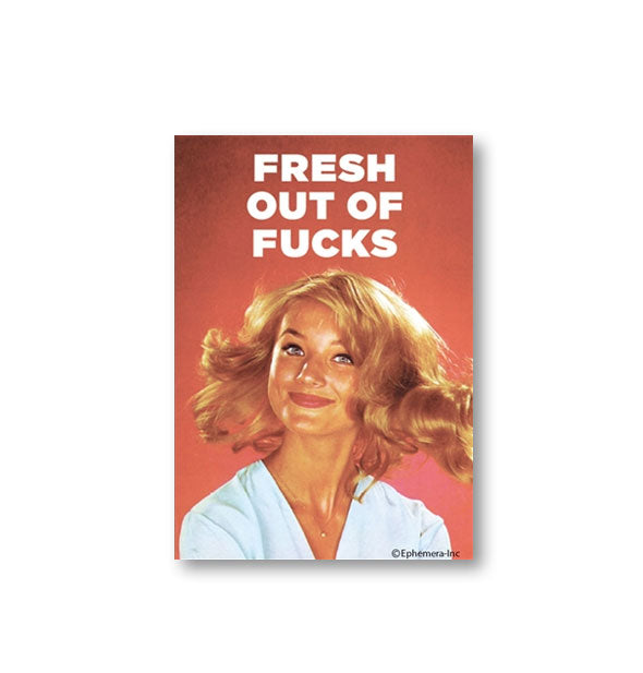 Rectangular red magnet with image of smiling woman flipping her hair says, "Fresh out of fucks"