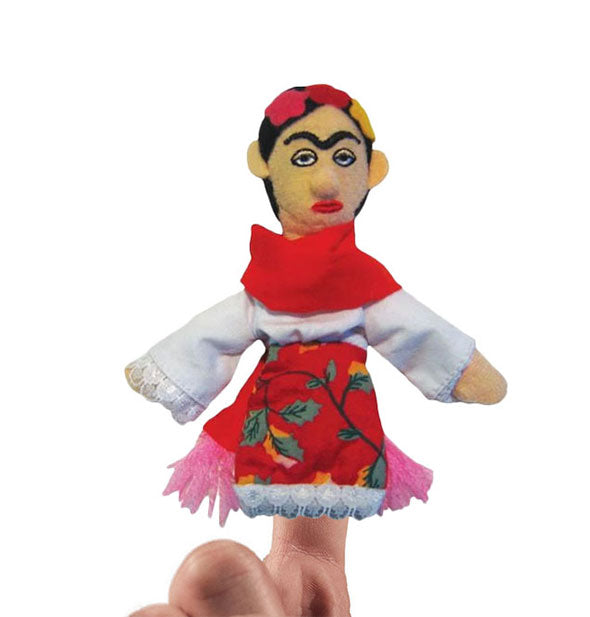 A hand models a finger puppet bearing the likeness of artist Frida Kahlo