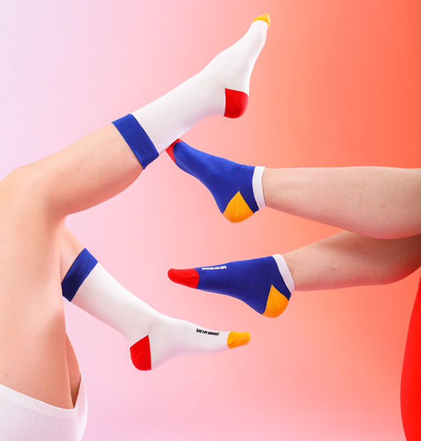 Models with legs in the air wear pairs of crew and ankle style socks in primary colors: Blue, white, red, and yellow