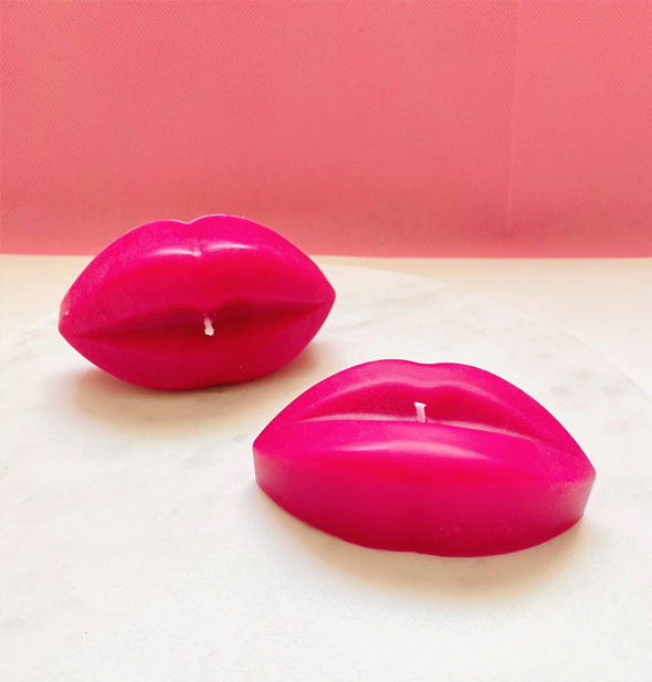Two pink candles shaped like lips