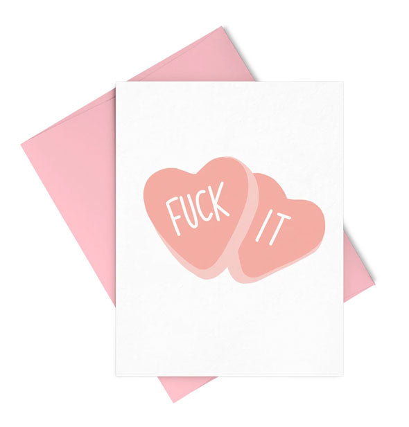 White greeting card with matching pink envelope features candy heart illustrations that say, "Fuck It"