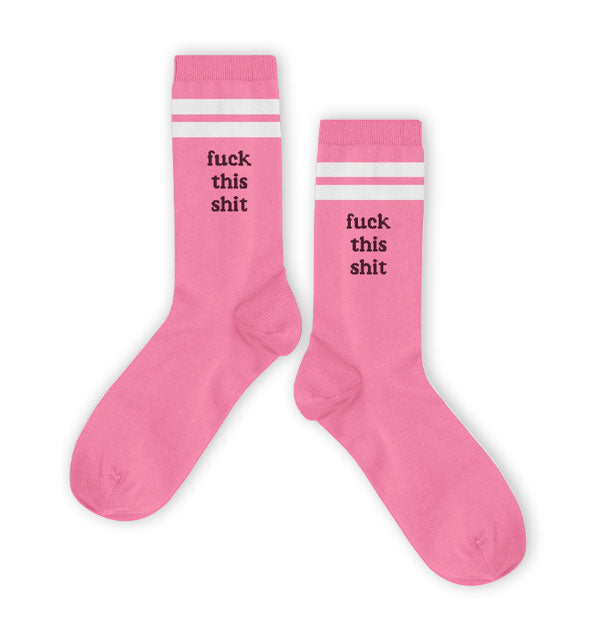 Pair of pink crew socks with two white stripes near the top say, "Fuck this shit" in dark lettering on the side of each ankle