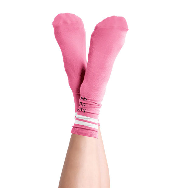 Model wears a pair of pink and white Fuck This Shit socks