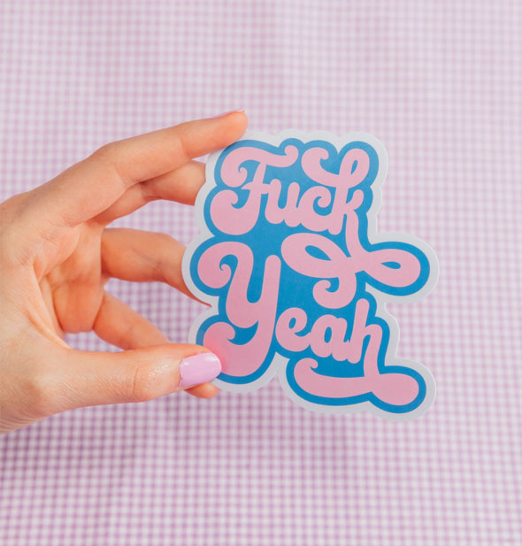 Model's hand holds a Fuck Yeah sticker