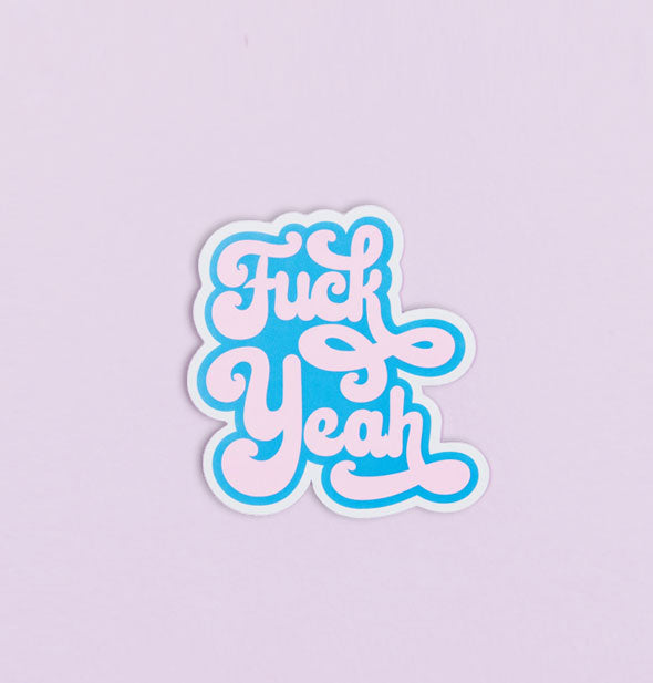 Blue and pink sticker says, "Fuck Yeah" in retro-style script font