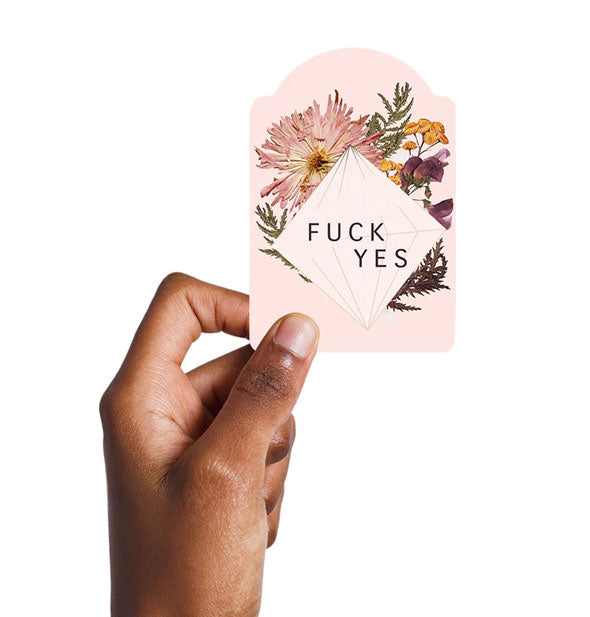 Model's hand holds the Fuck Yes sticker for size reference