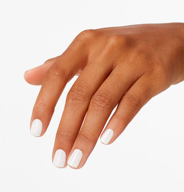 Model's hand wears a white shade of nail polish