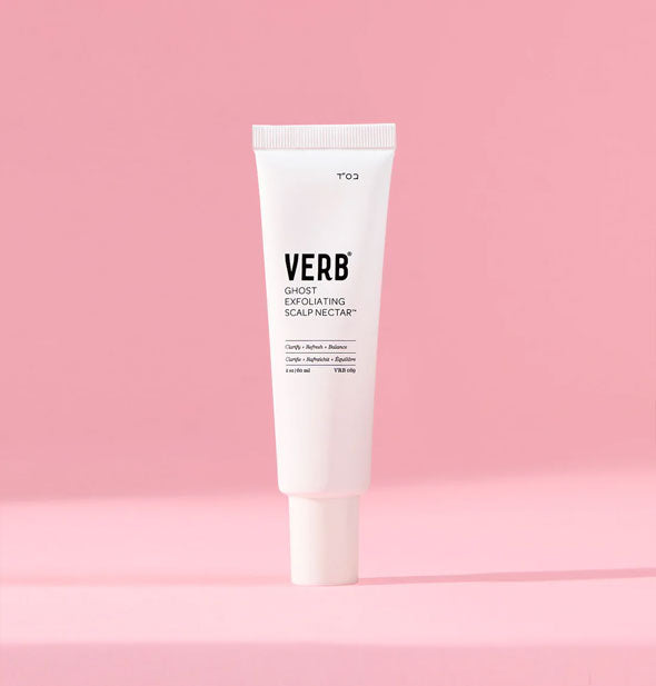 White tube of Verb Ghost Exfoliating Scalp Nectar against a pink background