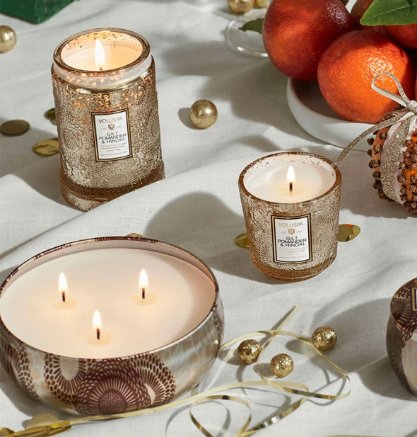 Staged Voluspa candles with holiday-inspired decorations