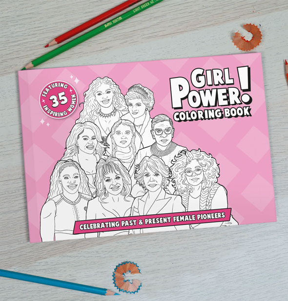 Cover of Girl Power! Coloring Book: Celebrating Past & Present Female Pioneers on gray wooden surface with colored pencils and pencil shavings surrounding it