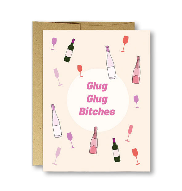 Cream-colored greeting card on top of kraft envelope says, "Glug Glug Bitches" surrounded by wine bottle and wine glass illustrations