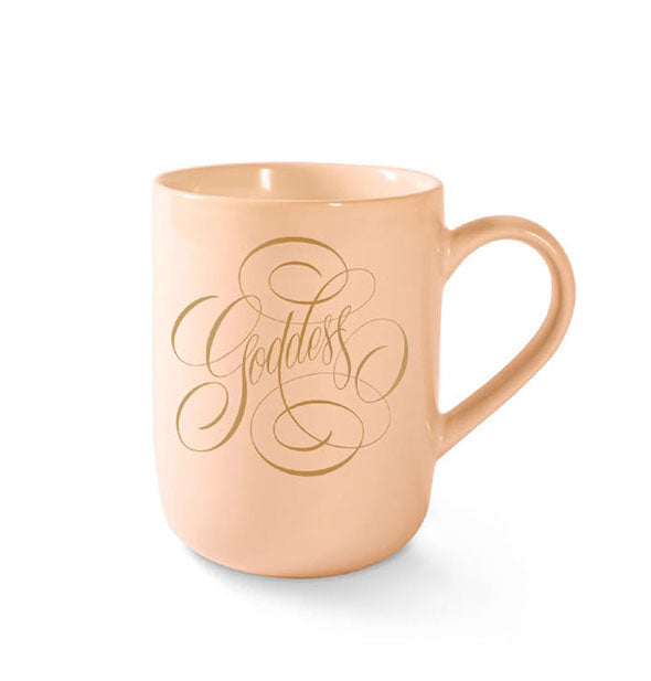 Peach-colored coffee mug with rounded base says, "Goddess" in decorative gold script with flourishes
