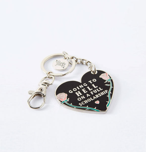 Black heart-shaped enamel keychain with silver ring and clasp says, "Going to hell on a full scholarship" with heart accent inside a thorny rose border