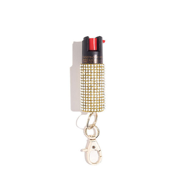 Gold rhinestone-encrusted pepper spray canister with rose gold lobster clasp attached