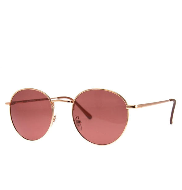 Sunglasses with rounded gold metal frame and rose-colored lenses