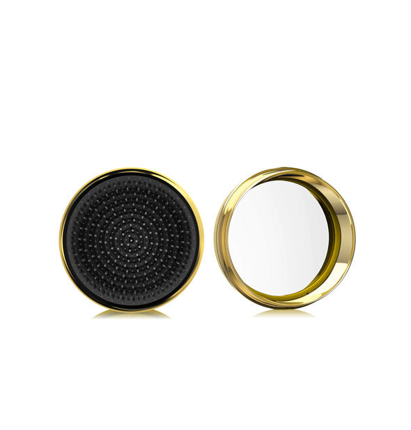 Round black and gold macaron-shaped hairbrush shown open to reveal compact mirror inside