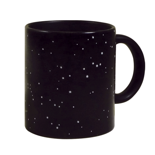 Black coffee mug with gold stars transforms to show labeled constellations when filled with a hot beverage