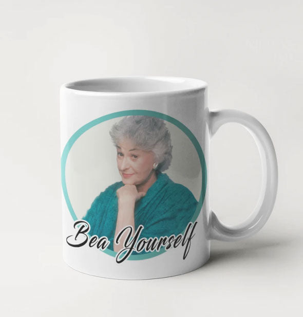 White coffee mug with likeness of the Golden Girls TV show character Dorothy Zbornak as played by Bea Arthur says, "Bea Yourself"