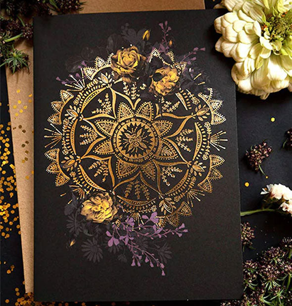 Black greeting card with shiny metallic gold mandala design surrounded by purple and orange flowers