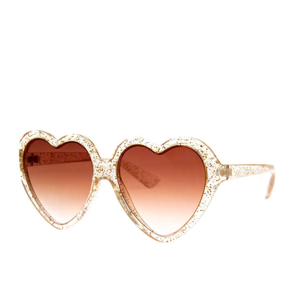 Heart-shaped sunglasses with gold glitter frame and amber lenses