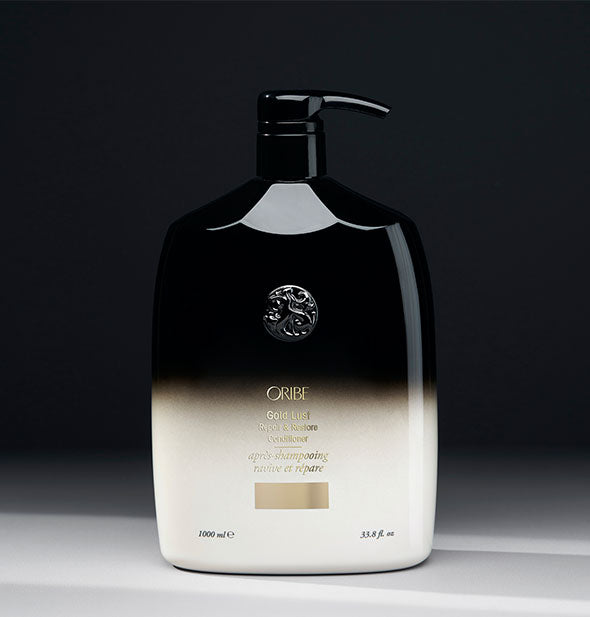 33.8 ounce black-to-white bottle of Oribe Gold Lust Repair & Restore Conditioner on gray background