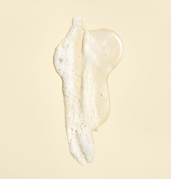 Sample of Oribe Gold Lust Repair & Restore Shampoo shown slightly lathered