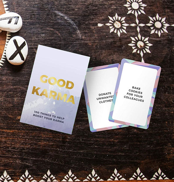 Box and samples from the Good Karma: 100 Things to Help Boost Your Karma card deck on decorated wooden surface