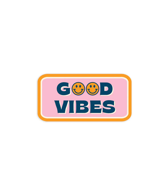Rectangular pink and orange sticker with curved corners says, "Good Vibes" in navy blue lettering with yellow smiley faces where the Os should be