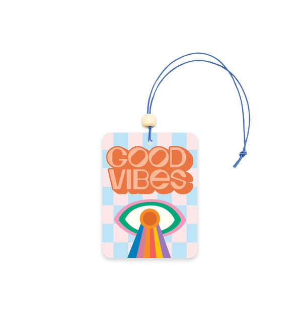 Rectangular air freshener card on blue string says, "Good Vibes" in orange lettering above a eye with rainbow design on a blue checkered background