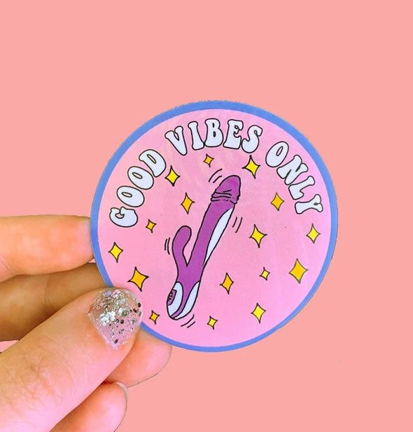 Model's hand holds a Good Vibes Only vibrator sticker for size reference