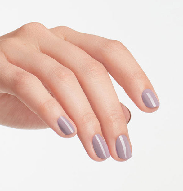 Model's hand wears light purple nail polish