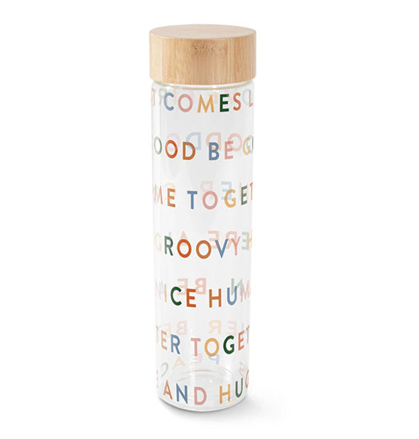 Clear glass water bottle features colorful wrap-around lettering and a bamboo lid