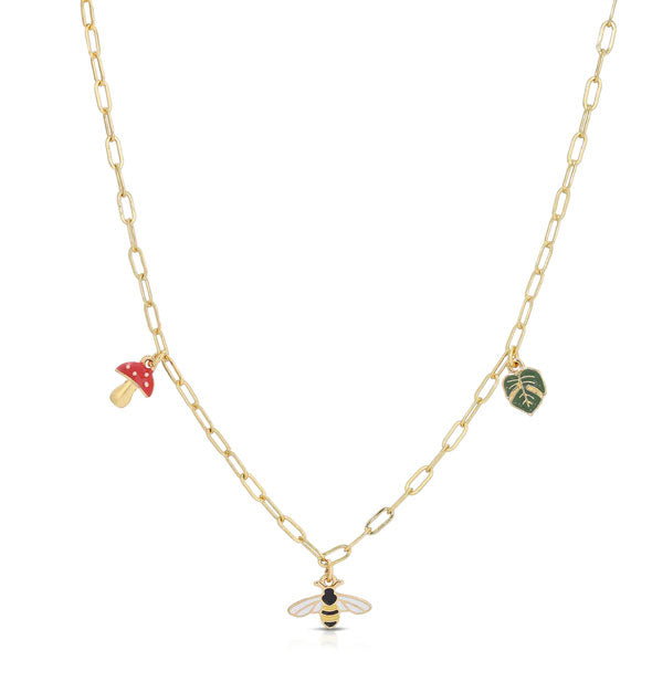 Gold necklace chain with red mushroom, bumblebee, and green leaf enamel charms hanging from it
