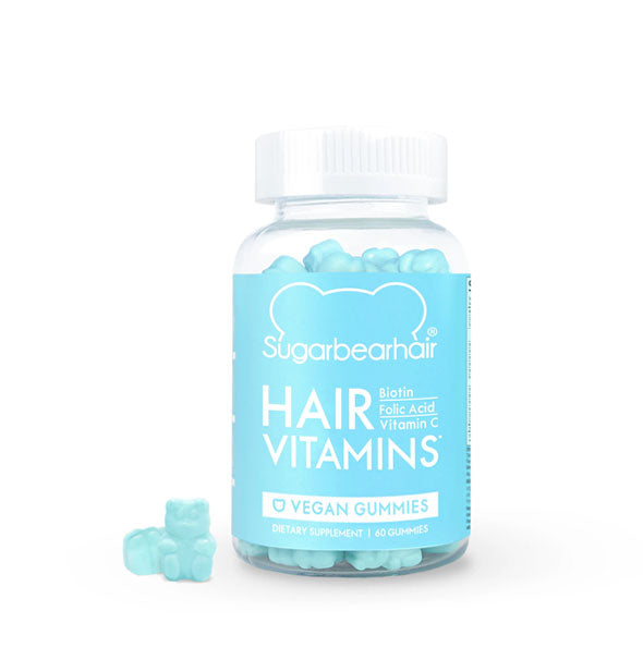 Clear bottle of SugarBearHair Hair Vitamins vegan blue gummy bear supplements with white cap, blue label, and two bears displayed to the side