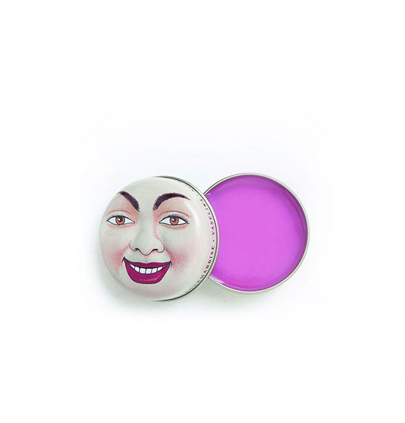 Opened round tin of purple lip balm with smiling face design on the lid
