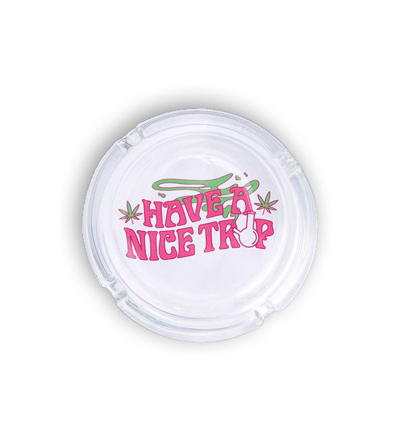 Round glass ashtray says, "Have a Nice Trip" with bong, pot leaves, and green smoke illustrations
