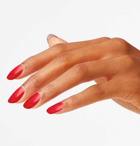 Model's hand wearing a bright shade of red nail polish